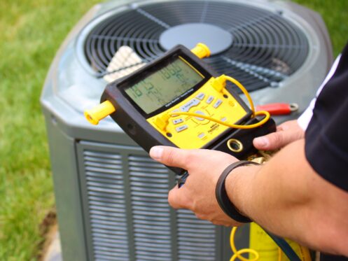 An AC tech checking an AC in Medina, OH