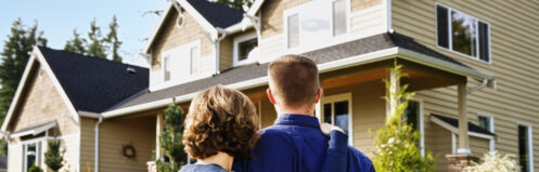 A couple admiring their home in Medina from the outside