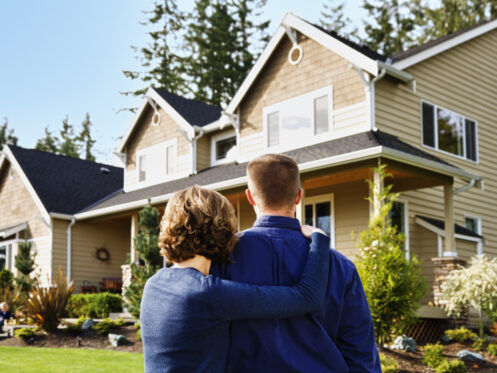 A couple admiring their home in Medina from the outside