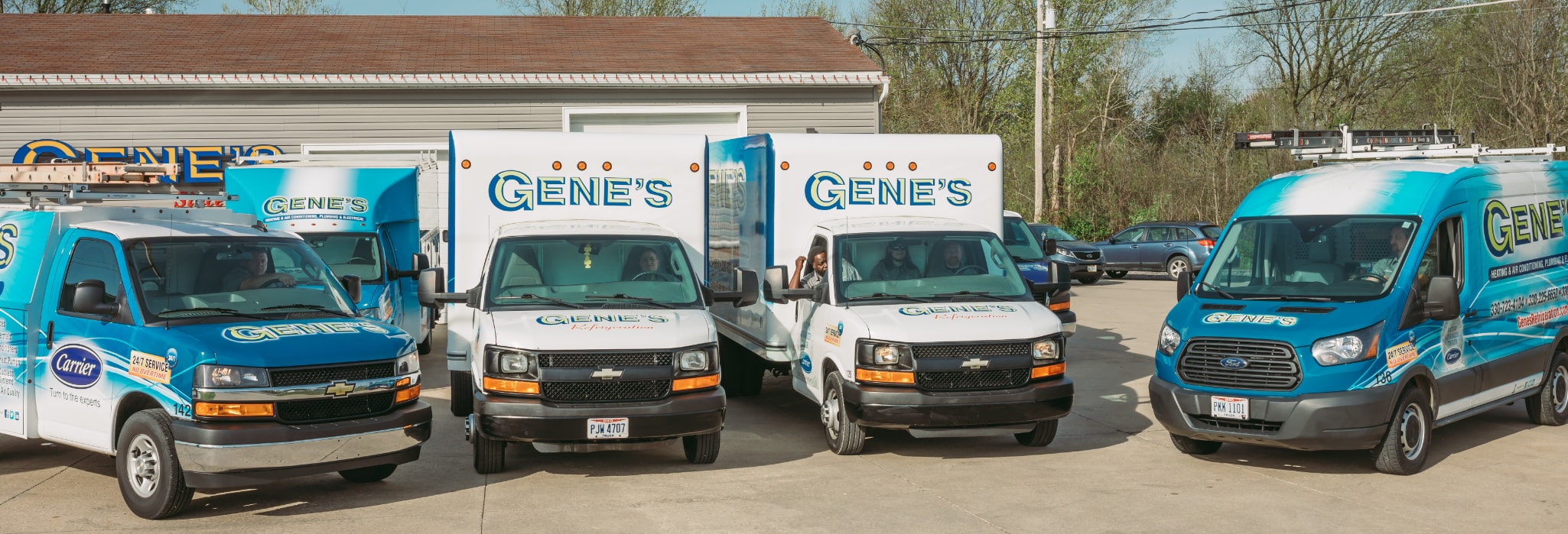 Five of Gene's service trucks parked in front of office.