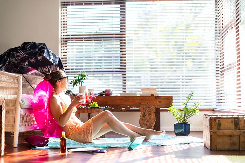 5 Ways to Lower Your Winter Heating Bill - Woman Sunbathing Indoors.